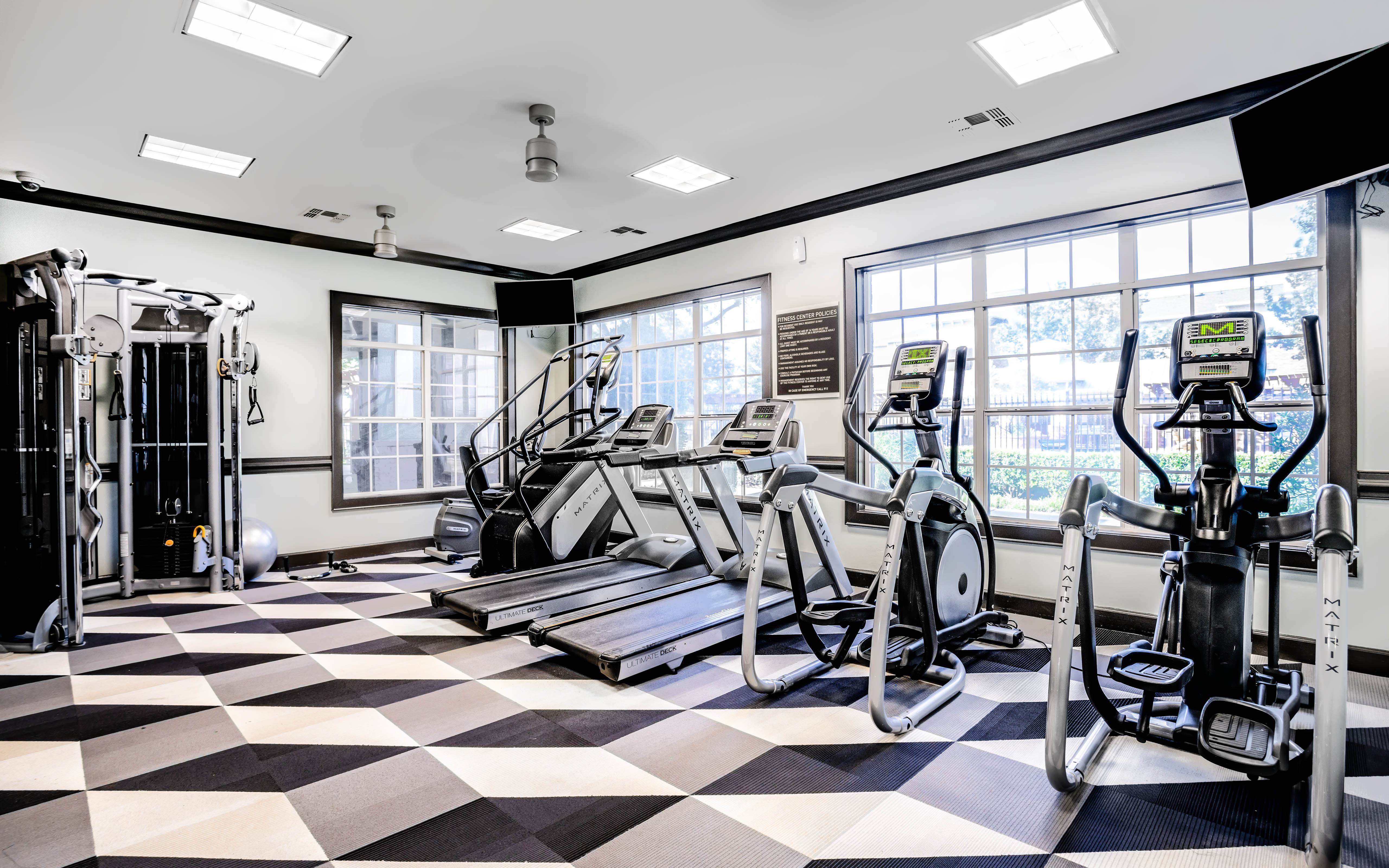 a fitness room with cardio machines